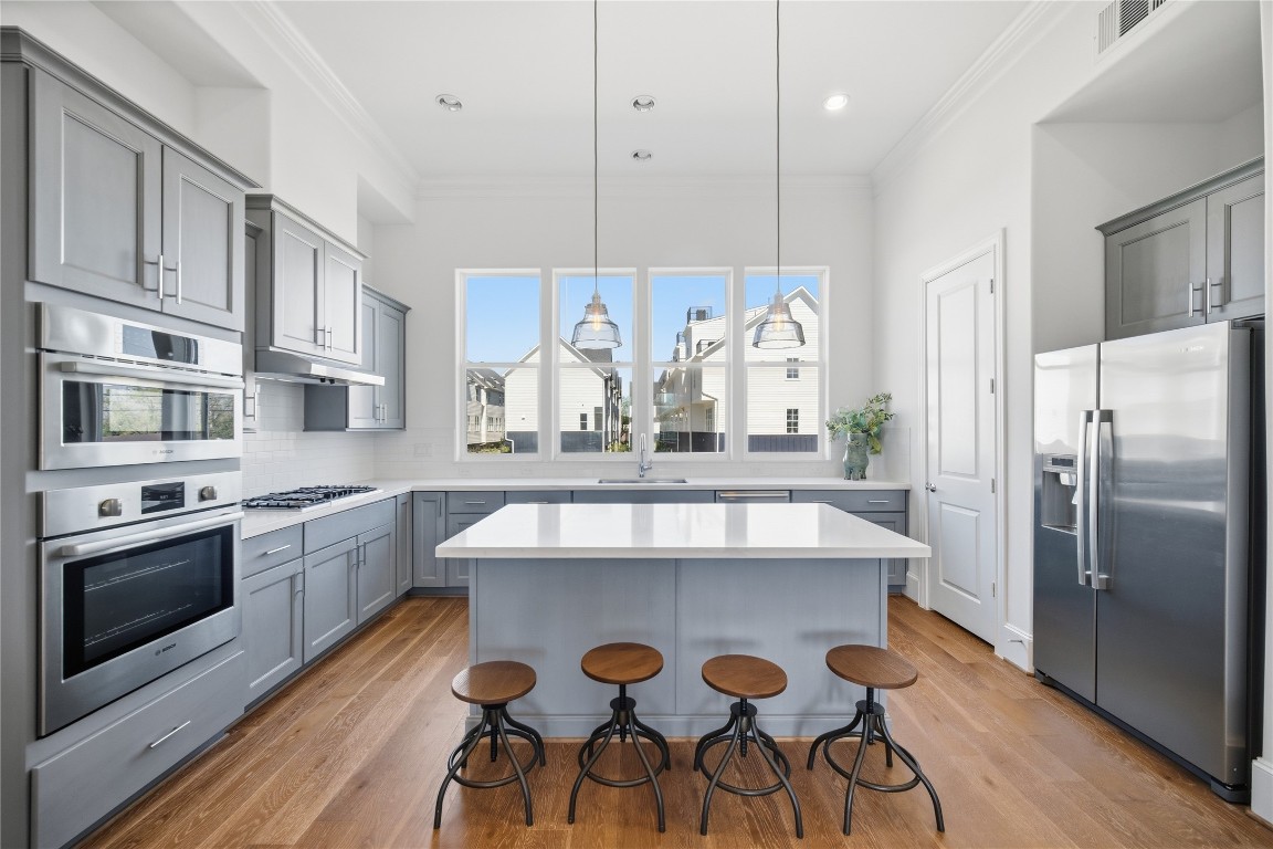 707 Bringhurst Street Houston, TX 77020 - Photo 9 of 23 a kitchen with stainless steel appliances granite countertop a white stove top oven a refrigerator with island and chairs