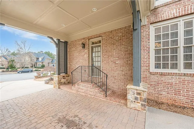 a kitchen with stainless steel appliances granite countertop wooden floors and a view of living room