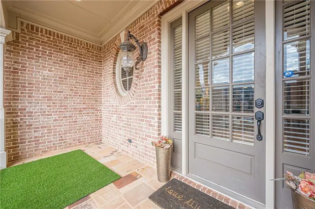 a kitchen with stainless steel appliances granite countertop a stove a sink a dining table and chairs with wooden floor