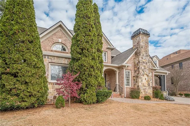 a front view of a house with a garden