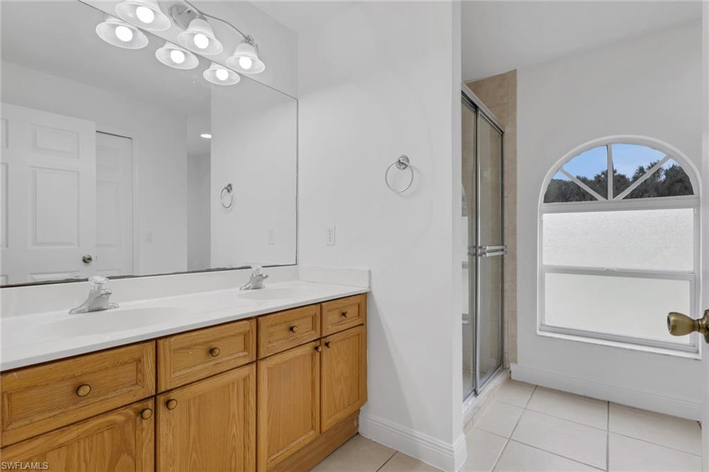 190 15th Street Southwest Naples, FL 34117 - Photo 13 of 26 a bathroom with a sink and a mirror