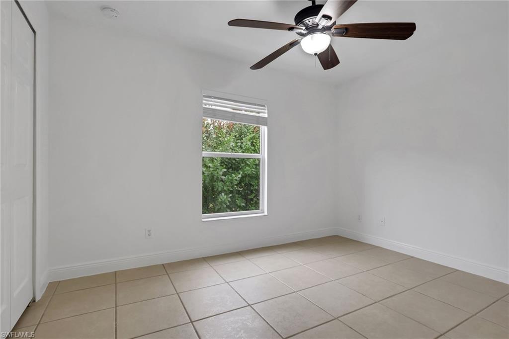 190 15th Street Southwest Naples, FL 34117 - Photo 17 of 26 an empty room with windows and fan