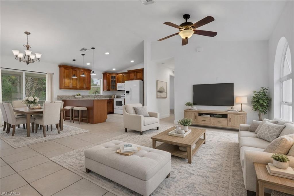 190 15th Street Southwest Naples, FL 34117 - Photo 2 of 26 a living room with furniture a fireplace and a flat screen tv