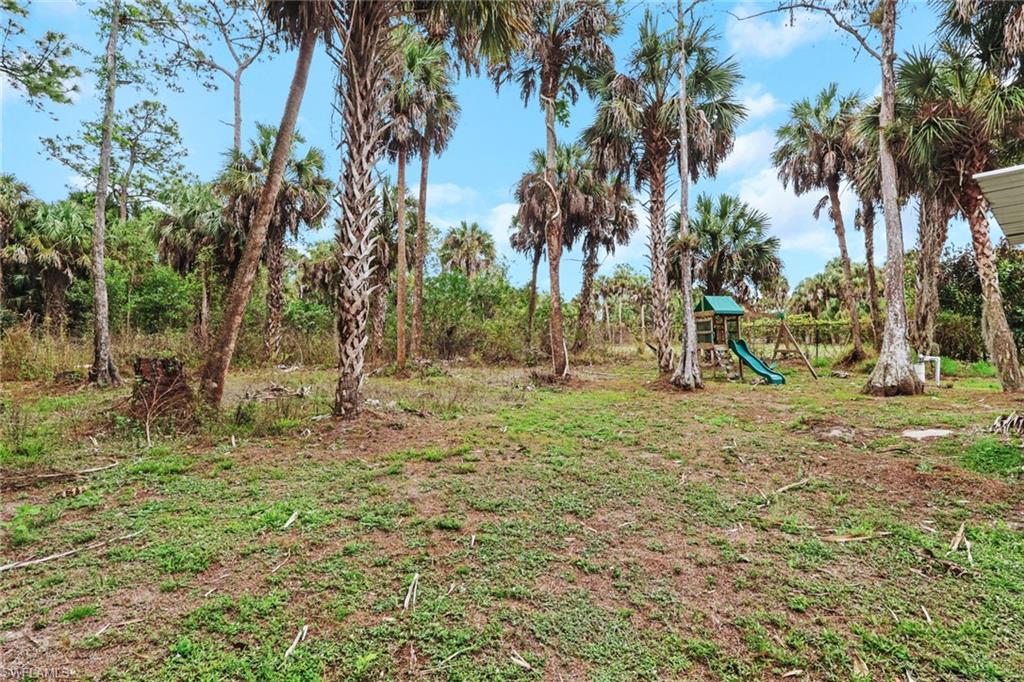 190 15th Street Southwest Naples, FL 34117 - Photo 22 of 26 a view of swings and a palm tree