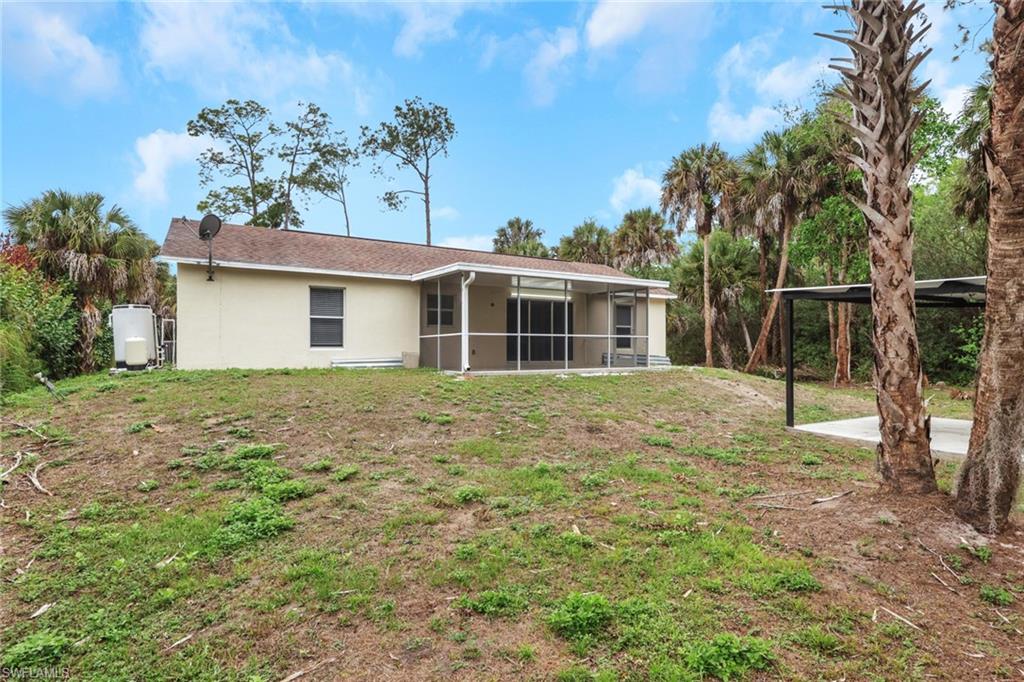 190 15th Street Southwest Naples, FL 34117 - Photo 23 of 26 a front view of a house with a garden