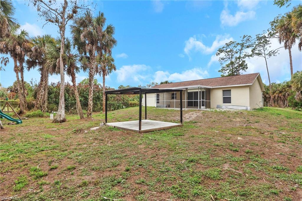190 15th Street Southwest Naples, FL 34117 - Photo 24 of 26 a house with trees in the background