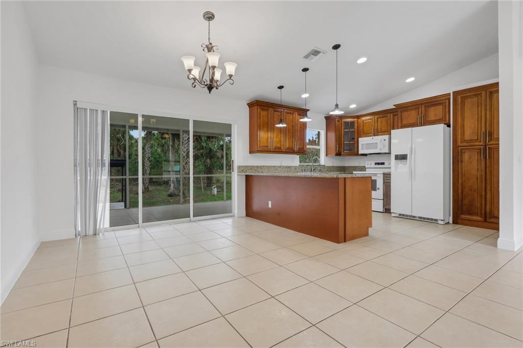 190 15th Street Southwest Naples, FL 34117 - Photo 3 of 26 a open kitchen with refrigerator and microwave