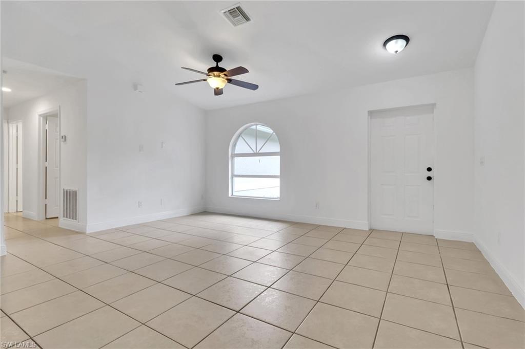 190 15th Street Southwest Naples, FL 34117 - Photo 5 of 26 an empty room with windows and fan