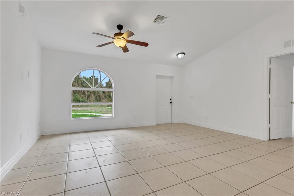 190 15th Street Southwest Naples, FL 34117 - Photo 6 of 26 an empty room with windows and fan