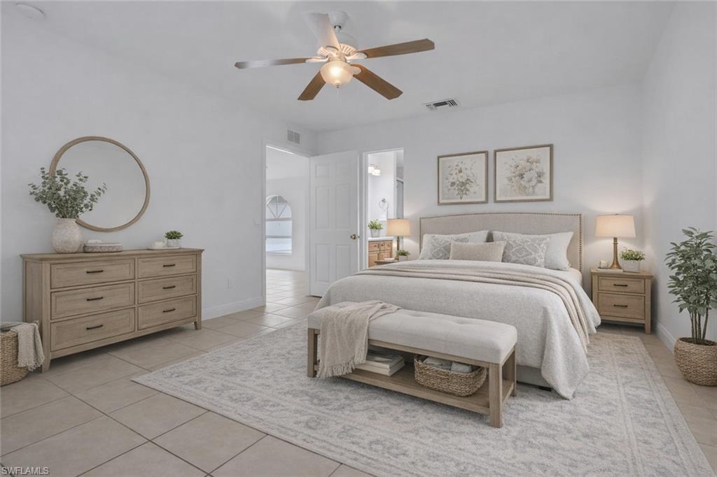 190 15th Street Southwest Naples, FL 34117 - Photo 10 of 26 a bedroom with a bed and a chandelier
