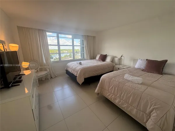 a bedroom with two beds and a couch