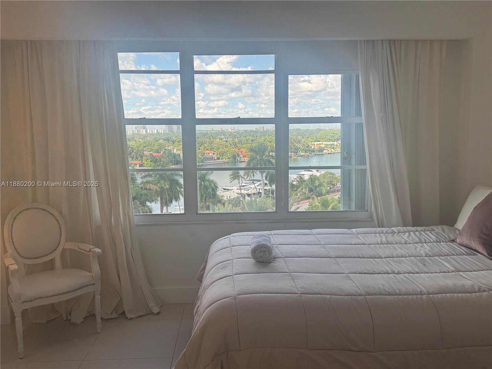 5151 Collins Avenue, Unit 923 Miami Beach, FL 33140 - Photo 12 of 32 a bedroom with a bed and a window