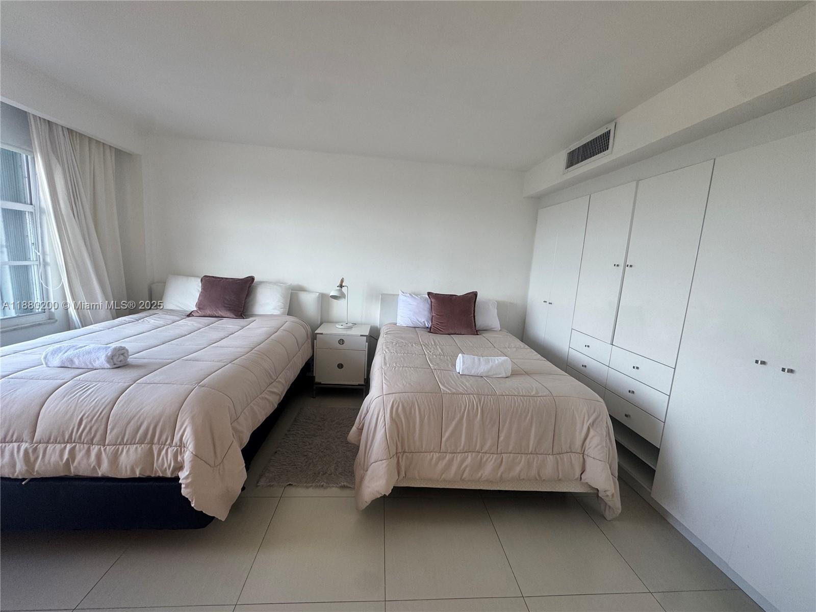 5151 Collins Avenue, Unit 923 Miami Beach, FL 33140 - Photo 13 of 32 a bedroom with a bed and a window