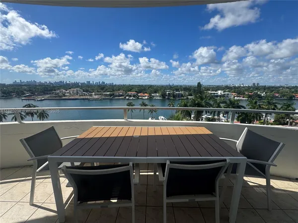 a view of swimming pool with outdoor seating and city view