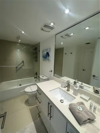 a bathroom with a double vanity sink mirror double and toilet