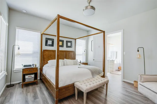 a bedroom with a bed and a wooden floor