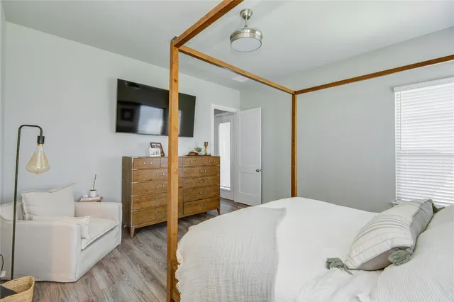 a bedroom with a bed and a flat screen tv