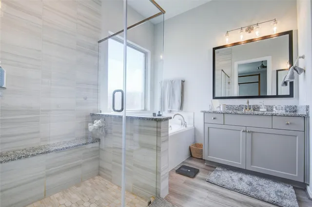 a bathroom with a double vanity sink a mirror and shower