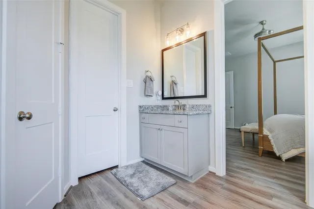 a bathroom with a granite countertop sink and a mirror