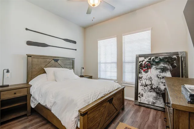 a bedroom with a bed and a dresser next to a window