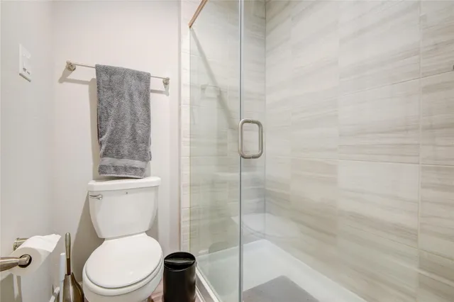 a white toilet sitting next to a bath tub shower