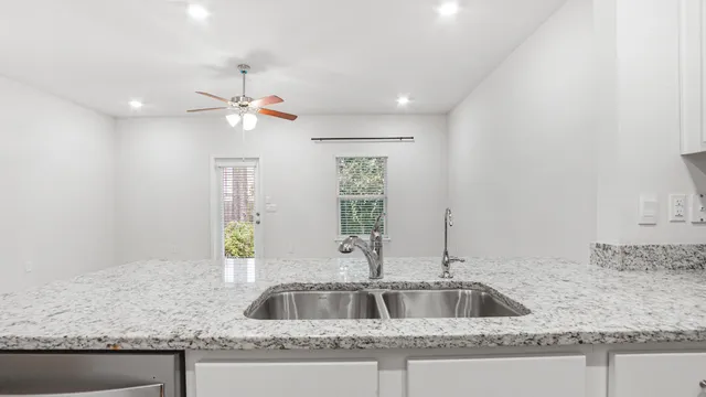 a kitchen with granite countertop a sink and a granite counter tops
