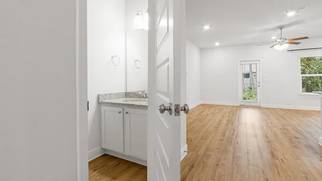 a view of bathroom with a sink mirror and shower
