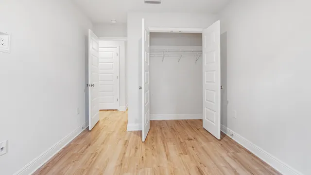 a view of a room with wooden floor