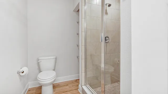 a bathroom with a toilet and a shower
