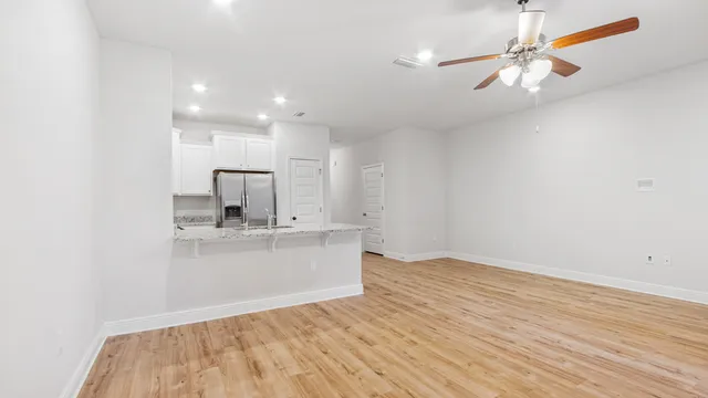 a view of kitchen with sink and wooden floor