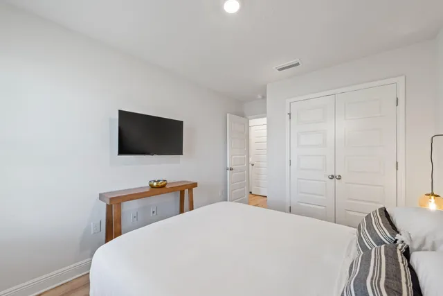 a bedroom with a bed and a flat screen tv