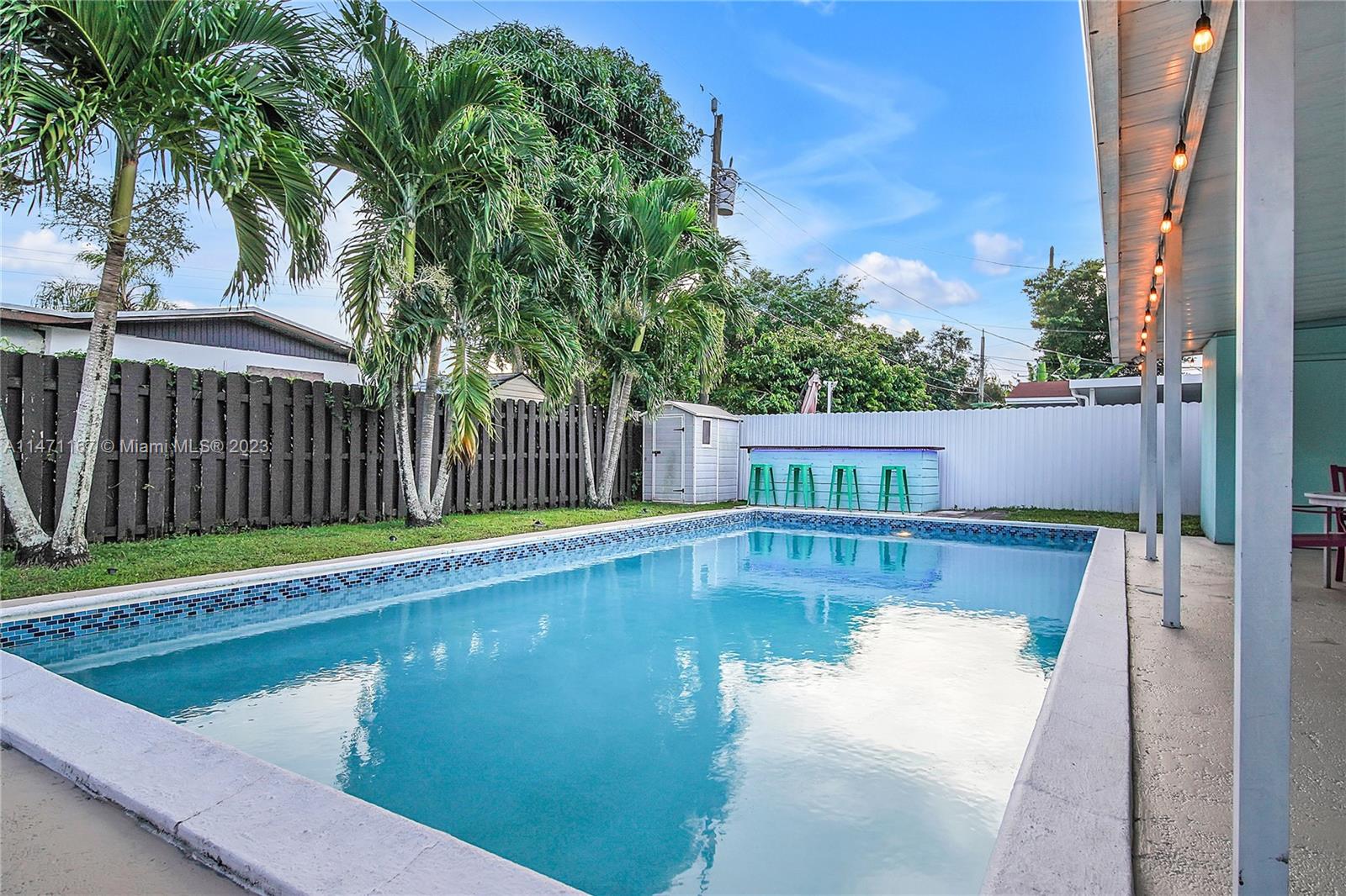 6750 Hope Street Hollywood, FL 33024 - Photo 14 of 54 a view of a swimming pool with a patio