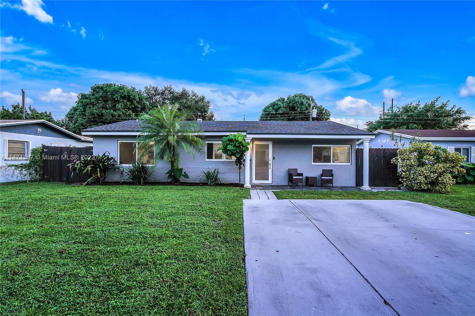 6750 Hope Street Hollywood, FL 33024 - Photo 2 of 54 a front view of a house with porch and garden