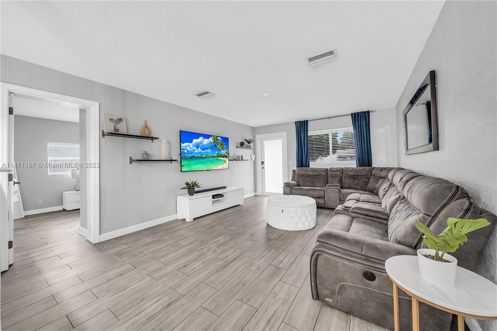 6750 Hope Street Hollywood, FL 33024 - Photo 29 of 54 a living room with furniture and a flat screen tv