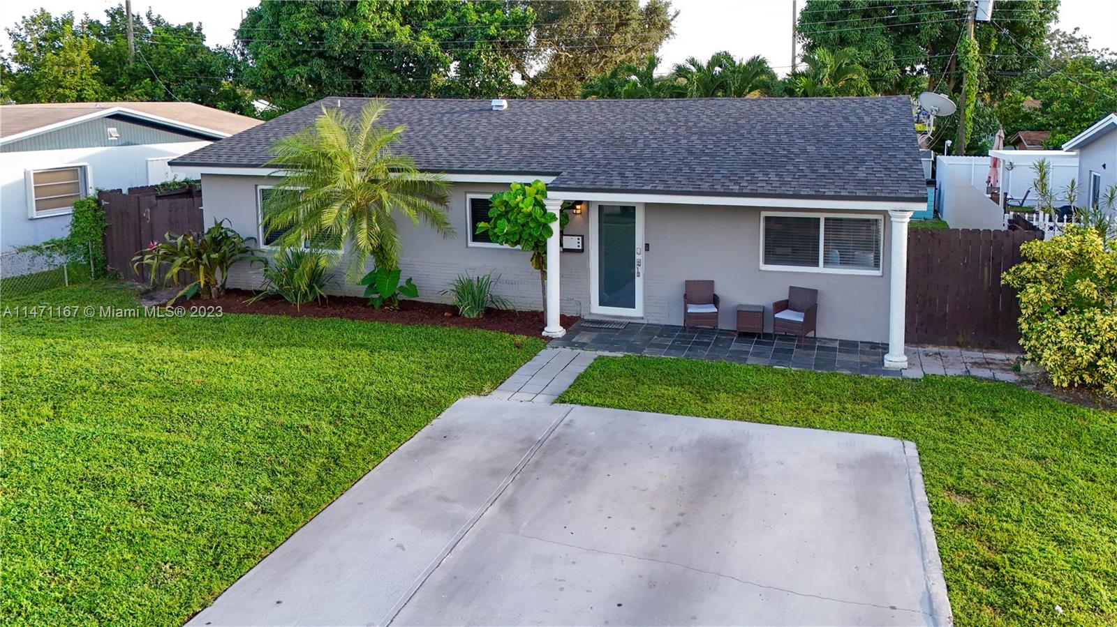 6750 Hope Street Hollywood, FL 33024 - Photo 3 of 54 a front view of house with yard and green space