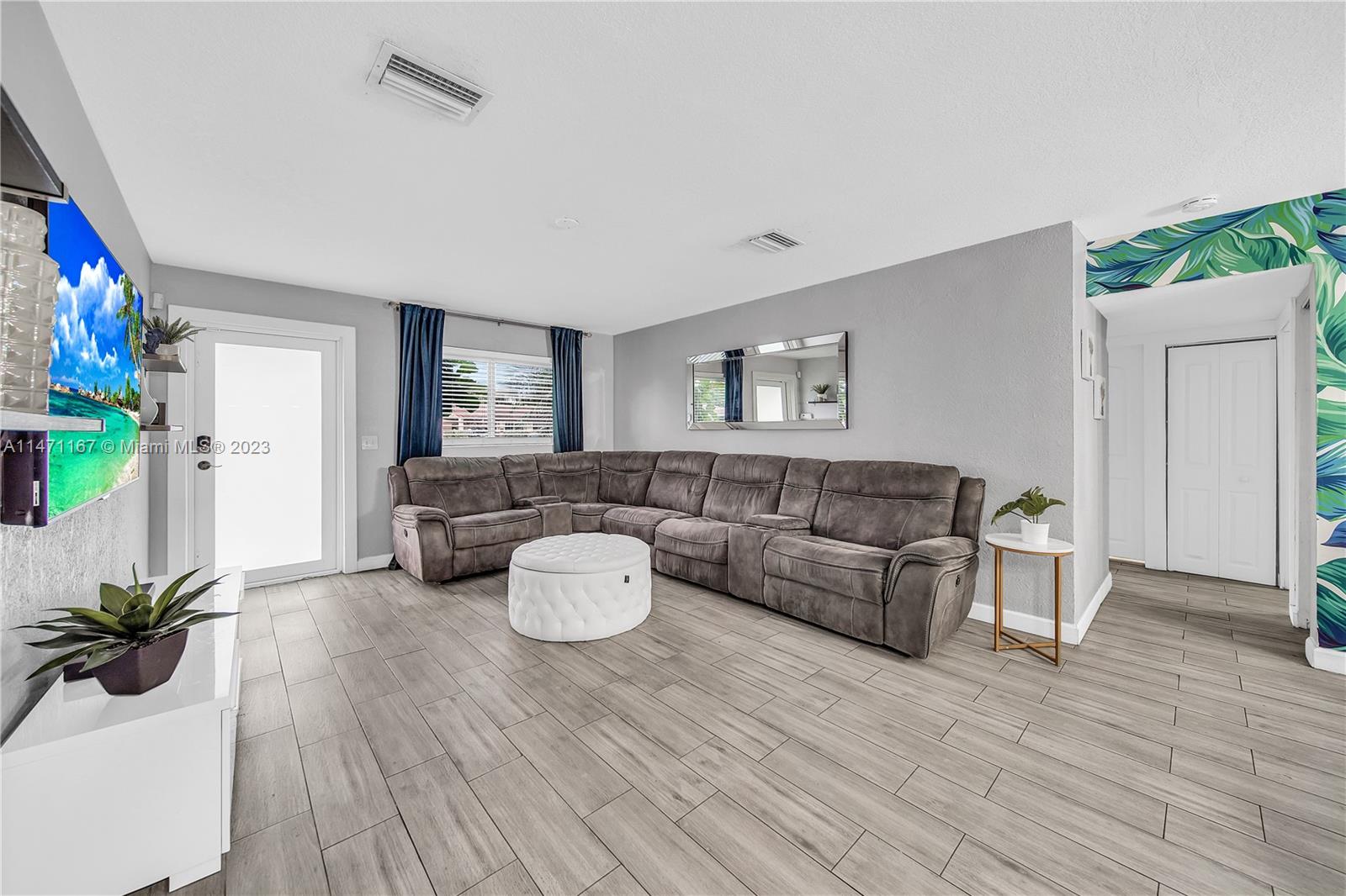 6750 Hope Street Hollywood, FL 33024 - Photo 31 of 54 a living room with furniture and wooden floor