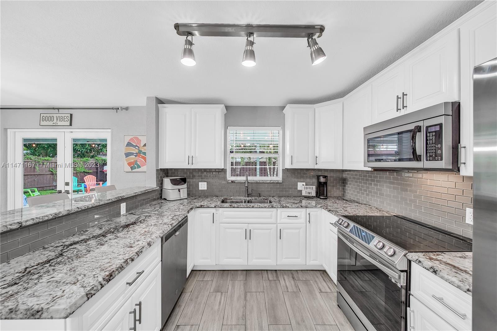 6750 Hope Street Hollywood, FL 33024 - Photo 38 of 54 a kitchen with a sink stove top oven and microwave