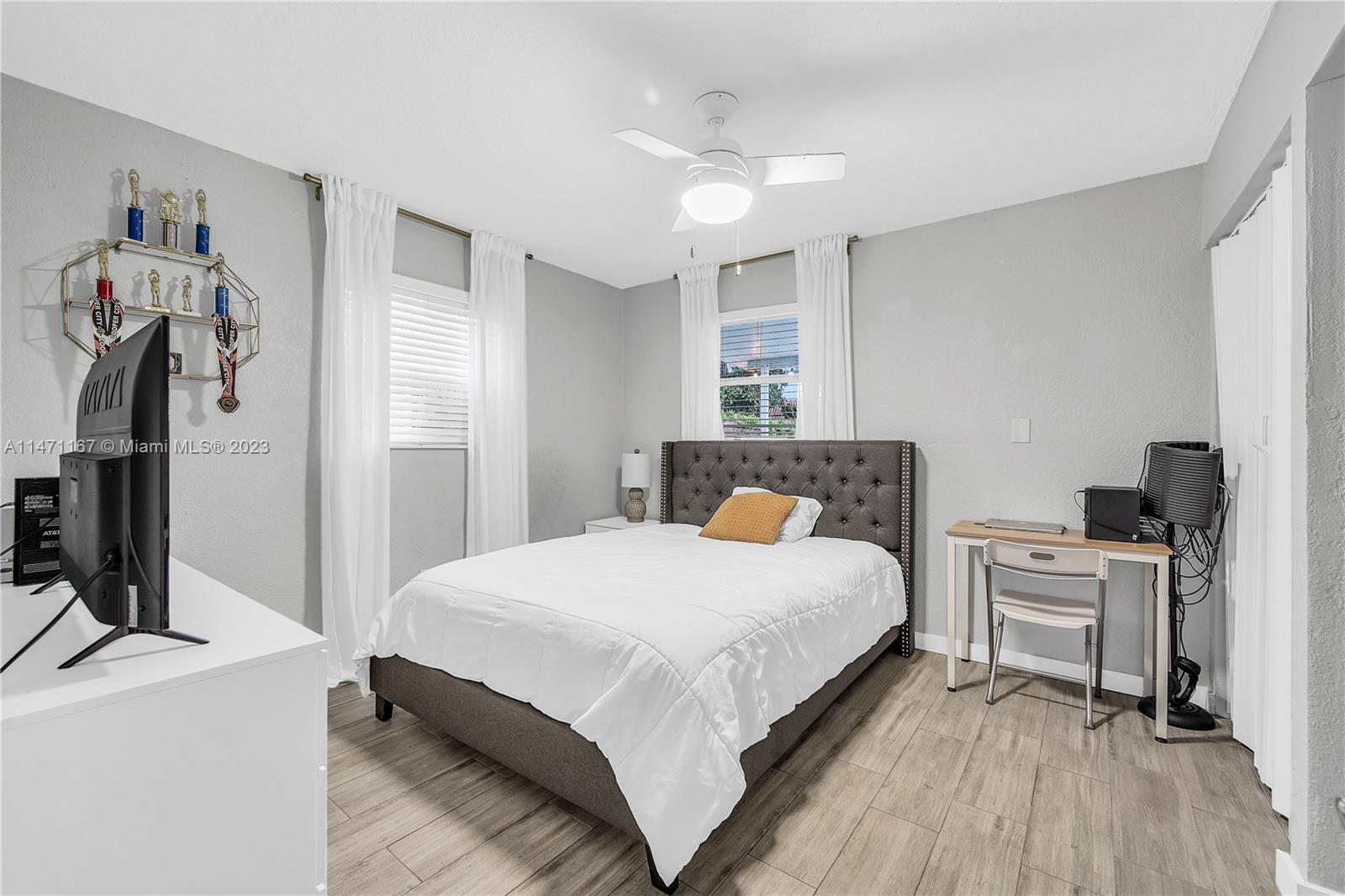 6750 Hope Street Hollywood, FL 33024 - Photo 46 of 54 a bedroom with a bed and a flat screen tv