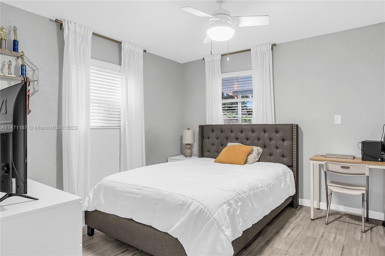 6750 Hope Street Hollywood, FL 33024 - Photo 47 of 54 a bedroom with a bed and wooden floor