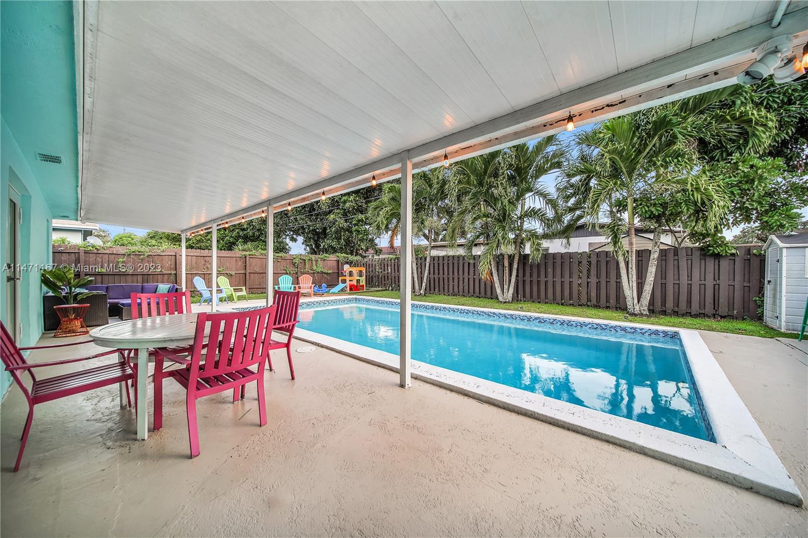 6750 Hope Street Hollywood, FL 33024 - Photo 5 of 54 a view of a patio with a table chairs and a backyard