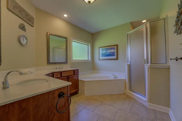 an empty room with windows and ceiling fan