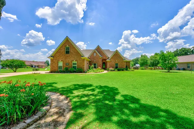 a view of an house with garden space and street view
