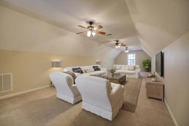 a living room with furniture a chandelier and a window