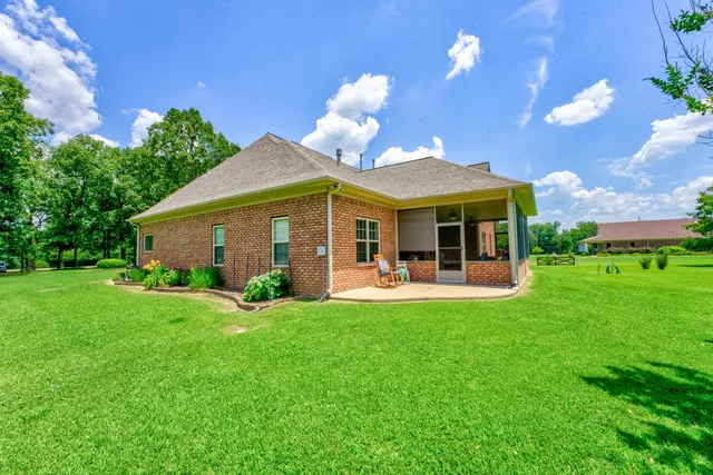 a view of a house with a yard porch and sitting area