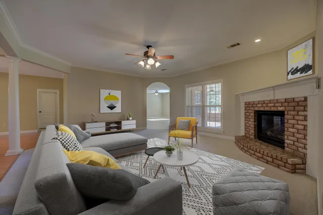 a living room with furniture a fireplace and a flat screen tv