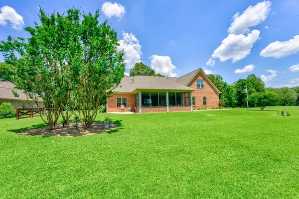 a view of a house with a yard porch and sitting area