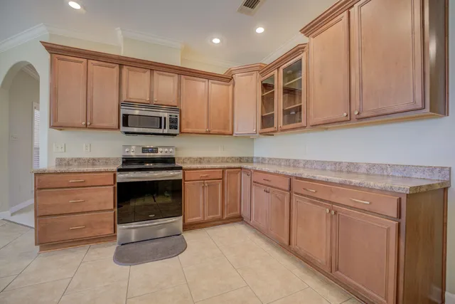 a kitchen with a stove microwave and cabinets