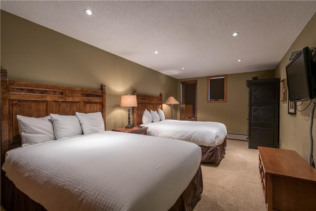 800 Copper Road, Unit 471 Copper Mountain, CO 80443 - Photo 14 of 19 a bed room with two bed and a television