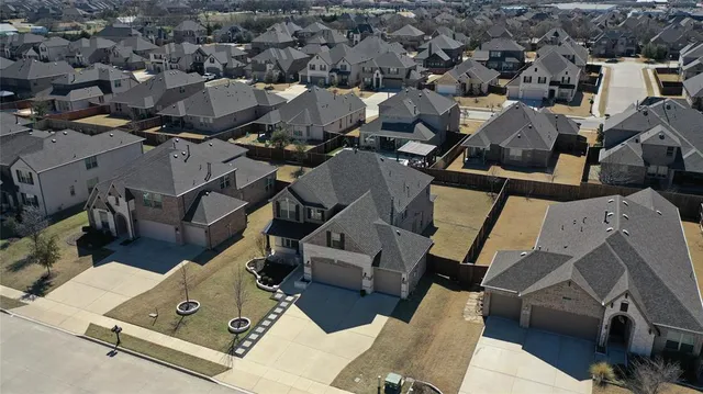 an aerial view of a house with backyard