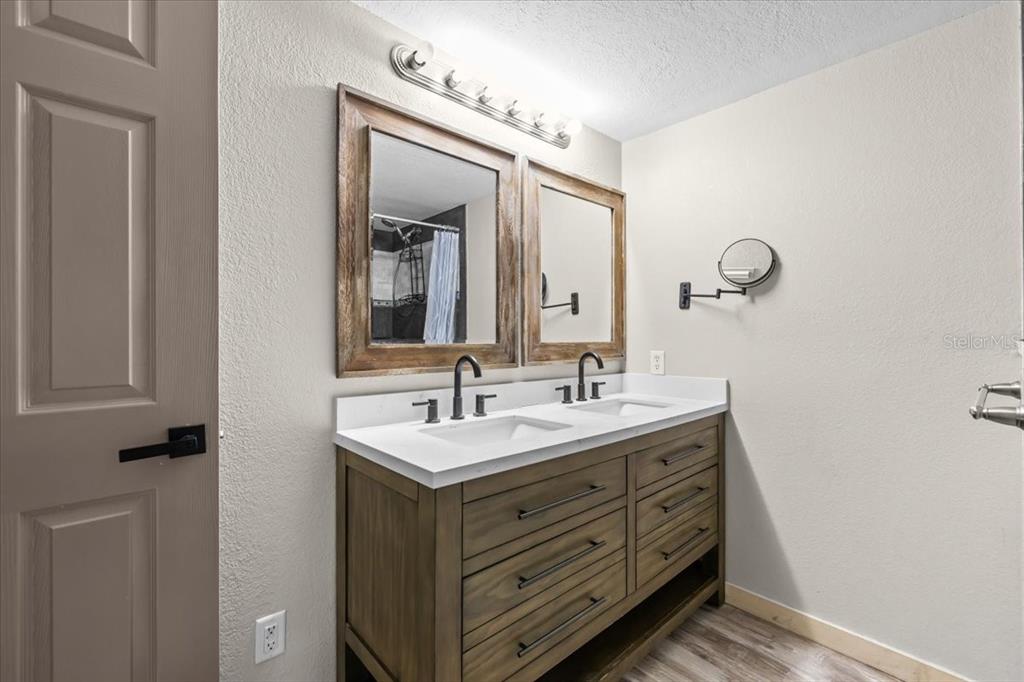 4805 Cooper Road Plant City, FL 33565 - Photo 19 of 45 a bathroom with a double vanity sink and a mirror